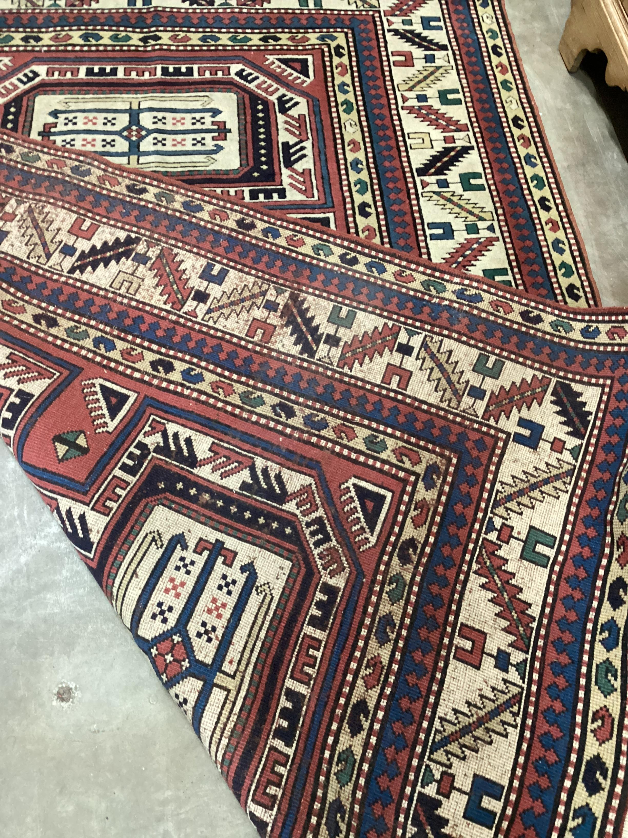A Caucasian red ground rug, 205 x 142cm